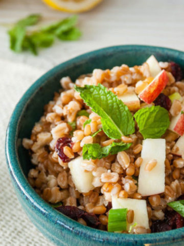 apple wheat berry salad in a blue bowl