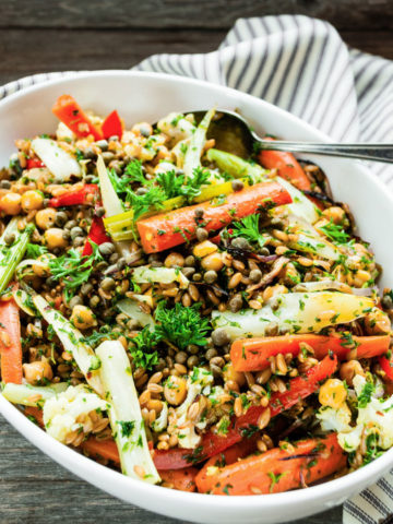 farro salad in a large white serving bowl