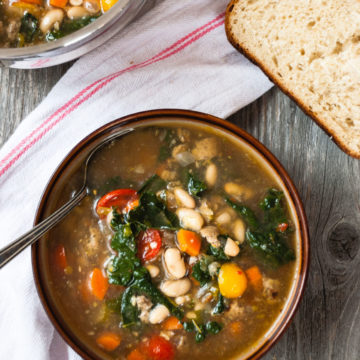 italian white bean soup in a serving bowl with bread