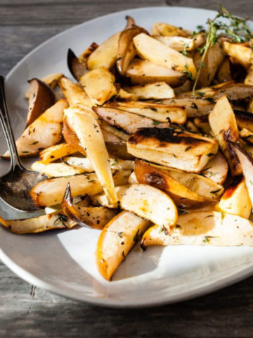 roasted parsnip and pears on a white serving dish