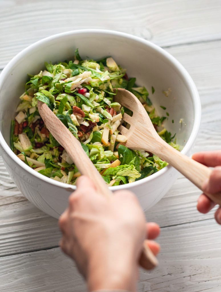 stirring brussels sprouts salad
