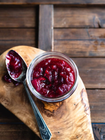 cranberry sauce in jar with a spoon