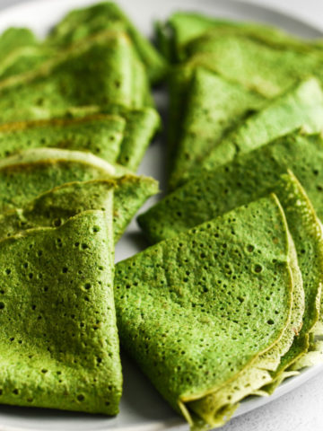 stack of folded spinach crepes