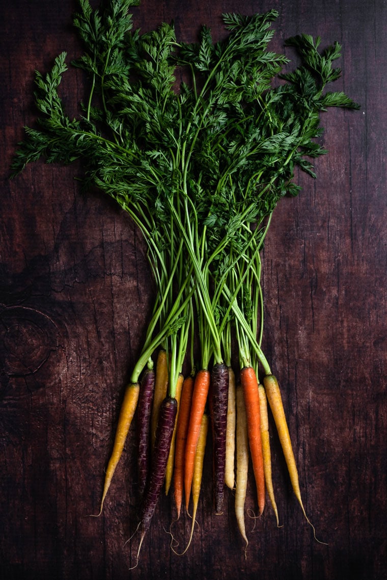 rainbow carrots on dark background