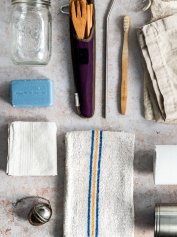 tools for going zero waste - reusable utensils, bar soap, bamboo toothbrush, jar, towel