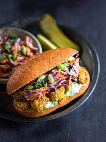 cauliflower sandwich with slaw and a pickle