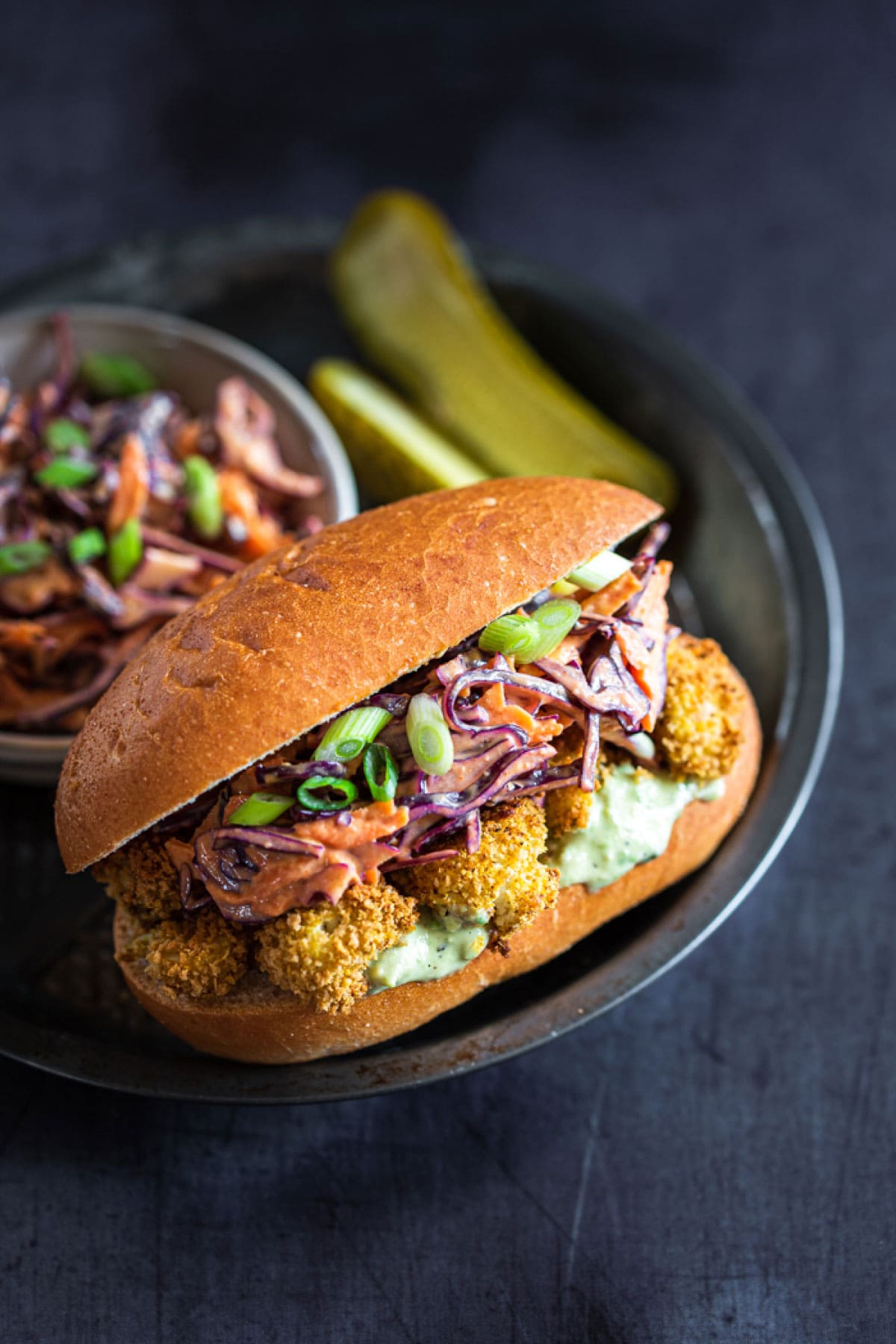 cauliflower sandwich with slaw and a pickle
