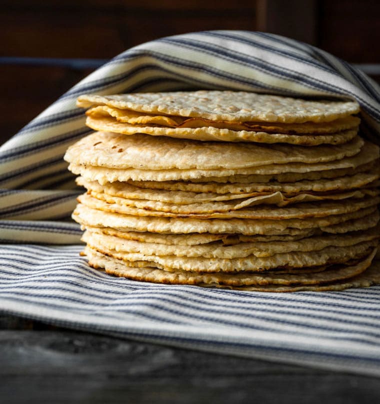corn tortillas stacked in a towel