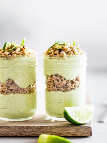 two jars of key lime pie parfait with limes