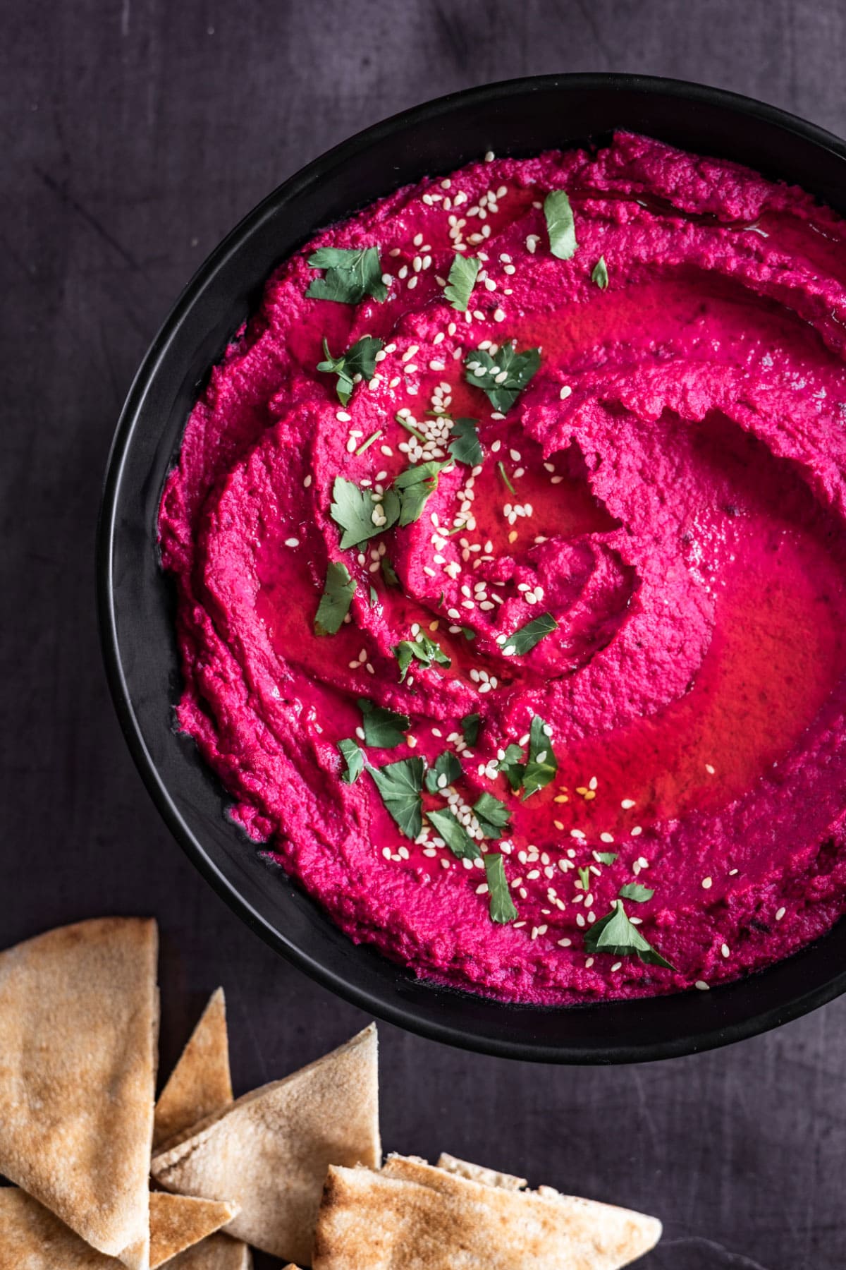 beet hummus with pita bread overhead