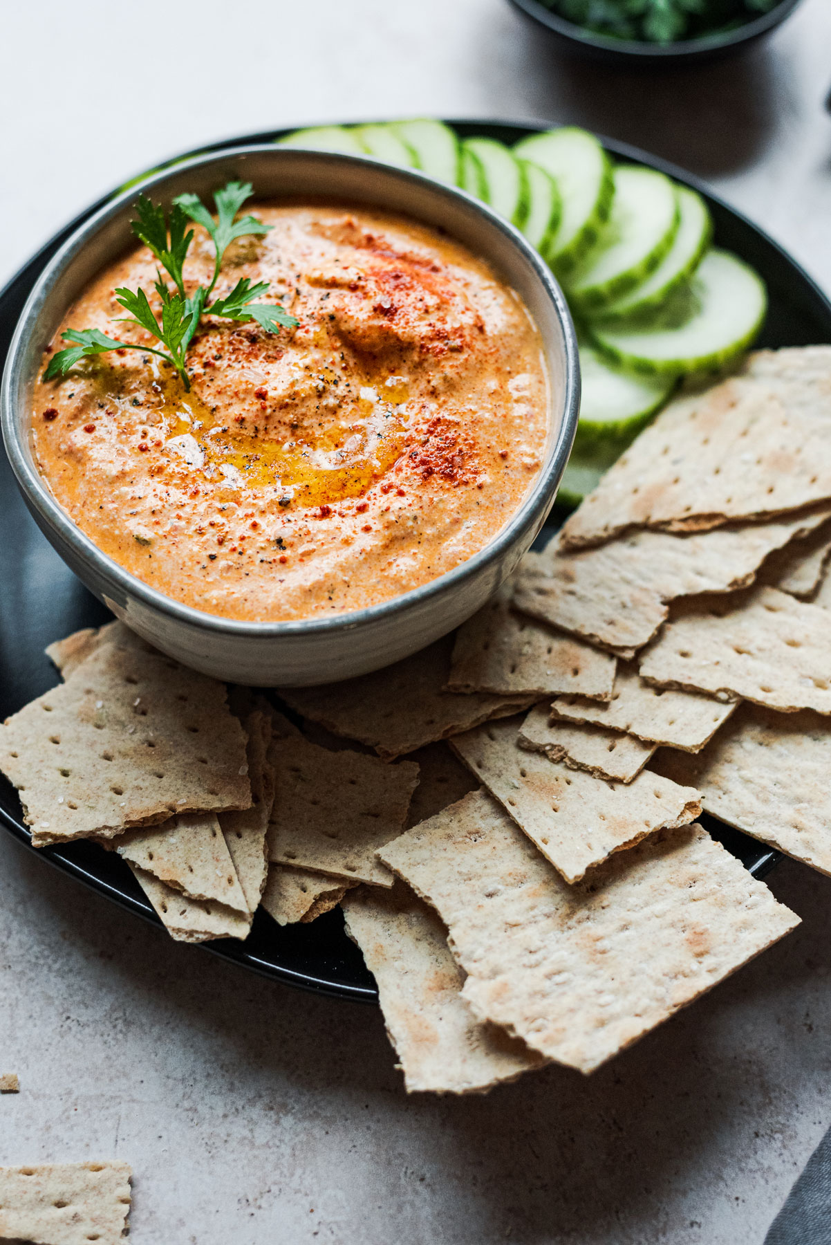 red pepper feta dip with crackers and cucumber