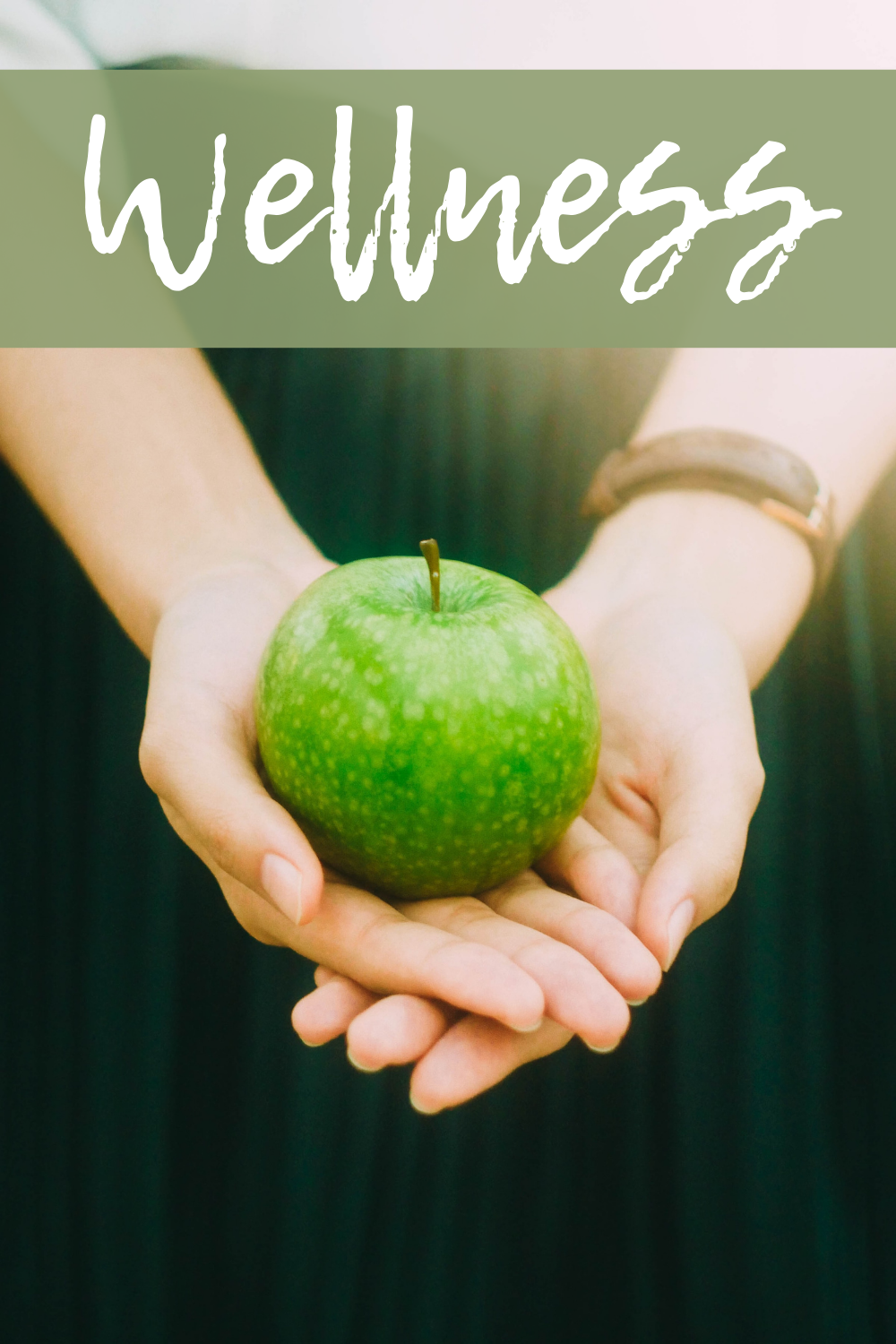 hands holding a green apple